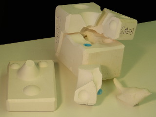 Four/five part bird mould with piece and bung removed Four/five part bird mould exploded to show seam lines